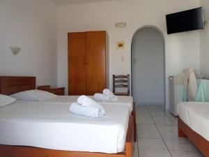 Cama ou camas em um quarto em Maria's Kouka Pension