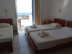 Cama ou camas em um quarto em Maria's Kouka Pension