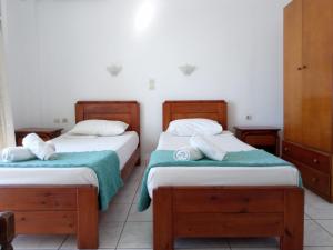 Cama ou camas em um quarto em Maria's Kouka Pension