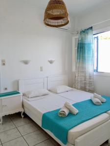 Cama ou camas em um quarto em Maria's Kouka Pension