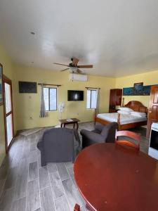 ein großes Wohnzimmer mit einem Bett und einem Tisch in der Unterkunft Hidden Treasure Vacation Home Lagoona bay cottage in Caye Caulker + 13 Fotos