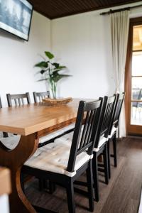 a dining room with a wooden table and chairs at Countryside cottage with mountain view in Lukovica pri Domžalah +14 photos
