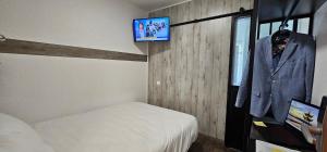 a bedroom with a bed and a tv on a wall at ClassEco Gent in Ghent