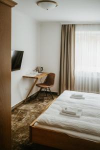 A bed or beds in a room at Pension Baranekhof - accommodation in nature - Baranek Resorts