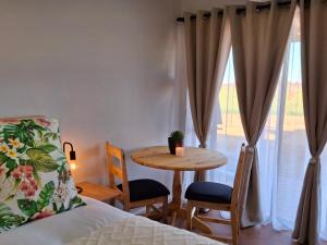a bedroom with a table and chairs next to a window at La Ford in Hopetown