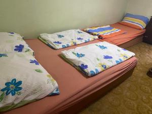 three twin beds sitting in a room at Aradi Apartman Siófok in Siófok