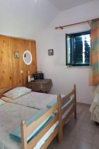 a bedroom with a large bed and a window at House Lidija in Postira