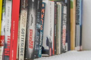 a row of books sitting on a shelf at Apartment Nedjeljka in Postira