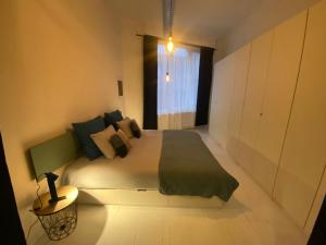 a bedroom with a large bed and a window at Loft St Remacle in Liège +4 photos