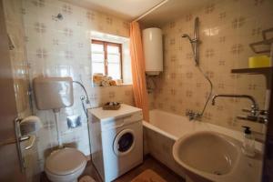 a bathroom with a washing machine and a sink at Apartments Ela in Sutivan +37 photos