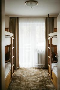A bed or beds in a room at Pension Baranekhof - accommodation in nature - Baranek Resorts