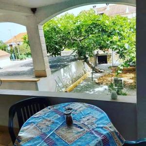 a table in a room with a view of a garden at Apartments Brti in Supetar