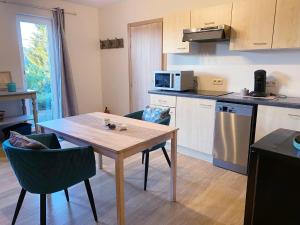 a kitchen with a table and chairs and a kitchen with a counter at La Maison des Senteurs in Francorchamps +207 photos