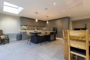 a large kitchen with a island in the middle at Bellevue Period House in County Armagh in Bessbrook