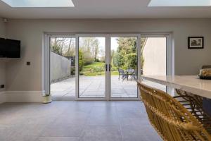 an open living room with a sliding glass door at Bellevue Period House in County Armagh in Bessbrook