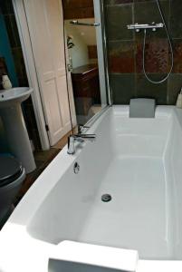 a bathroom with a white sink and a toilet at The Sewing Room in Hebden Bridge