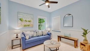 a living room with a blue couch and a table at A Royal Affair by Last Key Realty in Key West