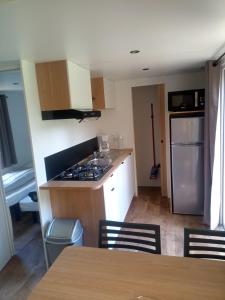 a kitchen with a sink and a stove top oven at Camping de Marcilly sur Vienne in Marcilly-sur-Vienne