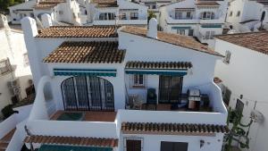 an aerial view of a white building with blue accents at Apartamento Berdica in Benitachell