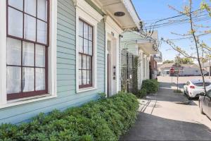 a blue house with a car parked in front of it at Cute 1bed 1bath walk to French Q and Bourbon St in New Orleans +5 photos
