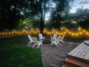 a group of white chairs sitting around a fire pit at The Hickory House with Firepit- Boat Ramp Access to Cedar Creek Lake in Tool