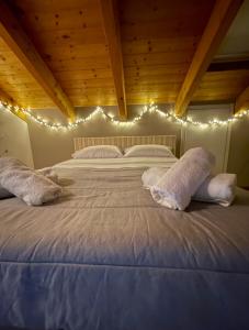 a bedroom with a large bed with lights on it at Casa Margot in Asti