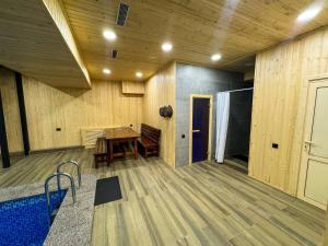 a room with a wooden floor and a wooden table at DOSTYK Hotel in Zyryanovsk