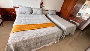 Postel nebo postele na pokoji v ubytování Em frente ao mar Praia da Costa dias incríveis