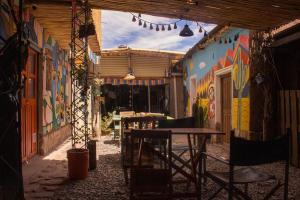 Un patio con una mesa y sillas en un edificio. en Giramundo Hostel, en Humahuaca