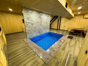 a swimming pool in the middle of a room at DOSTYK Hotel in Zyryanovsk