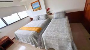 Postel nebo postele na pokoji v ubytování Em frente ao mar Praia da Costa dias incríveis