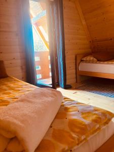 an attic room with a bed and a window at Bungalow Jajce 1 in Jezero