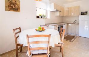 a kitchen with a table with a bowl of fruit on it at 2 Bedroom Amazing Home In Sveti Vid in Sveti Vid-Miholjice