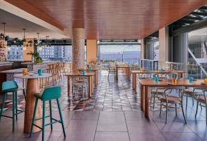 a restaurant with tables and chairs and a large window at Omni Boston Hotel at the Seaport in Boston