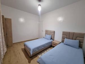 a room with two beds in a room at Spacious and Modern 2BR Apartment Rabat center in Rabat