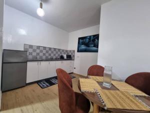 a dining room with a table and chairs and a kitchen at Spacious and Modern 2BR Apartment Rabat center in Rabat