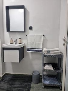a bathroom with a sink and a shelf with towels at Spacious and Modern 2BR Apartment Rabat center in Rabat +9 photos