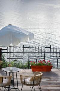 a patio with a table and chairs and an umbrella at Hosteria El Condado in San Carlos de Bariloche +85 photos