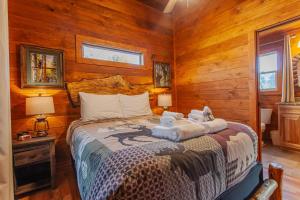 a bedroom with a bed with towels on it at Cozy Cub at Deep Creek in Bryson City