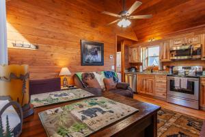 a living room with a couch and a table at Cozy Cub at Deep Creek in Bryson City