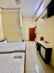 Postel nebo postele na pokoji v ubytování Thanh Tâm Hotel
