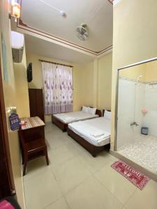 Postel nebo postele na pokoji v ubytování Thanh Tâm Hotel