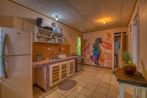 a kitchen with a refrigerator and a table in it at Casa Jacob in Talamanca