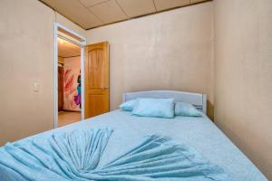 a bedroom with a bed with a blue blanket on it at Casa Jacob in Talamanca +2 photos