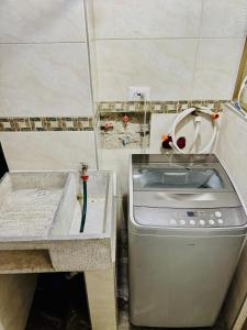 a kitchen with a sink and a stove at Tranquilidad a toda hora in Bogotá +7 photos