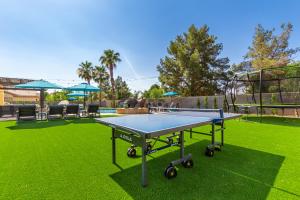 a ping pong table on the grass in a yard at The Grand Saguaro Amazing Gilbert Home in Gilbert