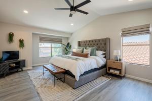 a bedroom with a large bed and a television at Dos Palmas - Gilbert Poolside Retreat in Gilbert +67 photos