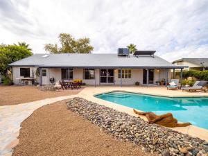 a house with a swimming pool in front of it at Royale Living in the Heart of Phoenix in Glendale