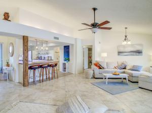 a living room and kitchen with a ceiling fan at Royale Living in the Heart of Phoenix in Glendale