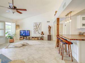 a living room with a ceiling fan and a tv at Royale Living in the Heart of Phoenix in Glendale